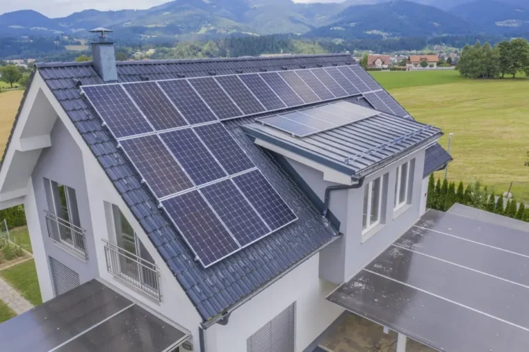 Aerial view of a house with solar panels on the roof.