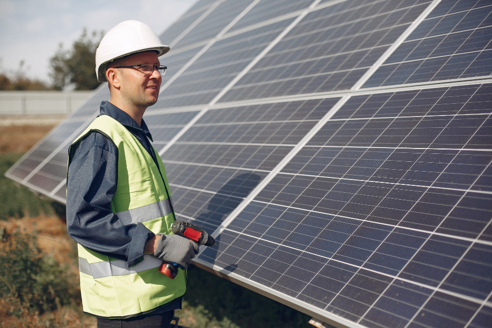 Man in a white helmet installing Solar Panels in Mandurah WA.