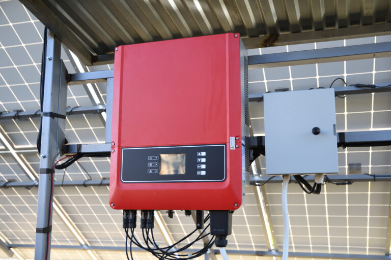 A solar battery and inverter installed on a metal frame under panels by a professional solar installer in Perth.