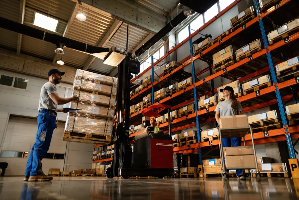 Warehouse staff operating a forklift under commercial solar Perth target storage facility.