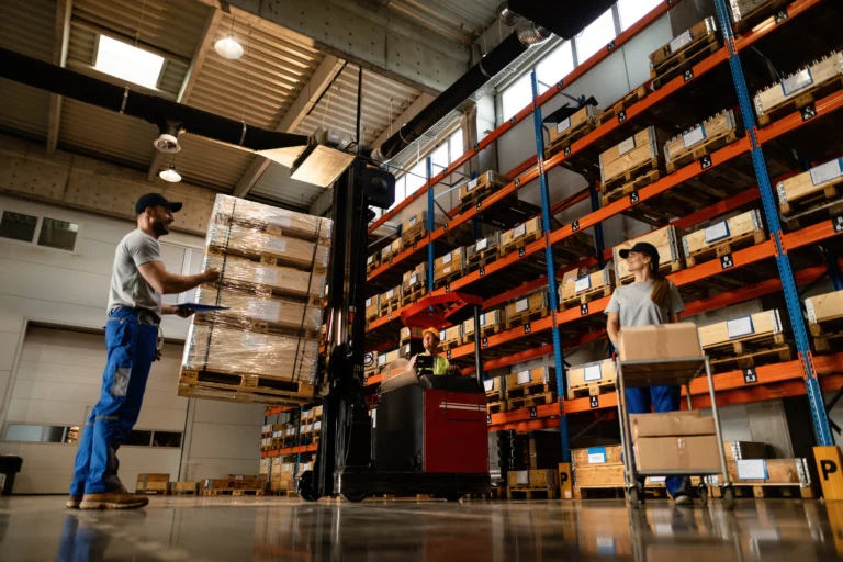 Warehouse staff operating a forklift under commercial solar Perth target storage facility.