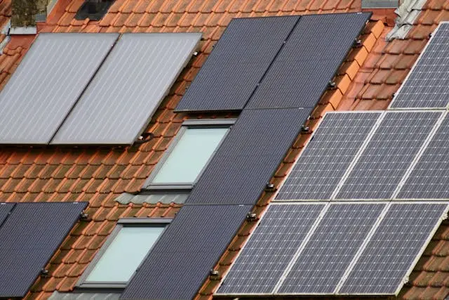 Close-up of several solar panels on a tiled roof.
