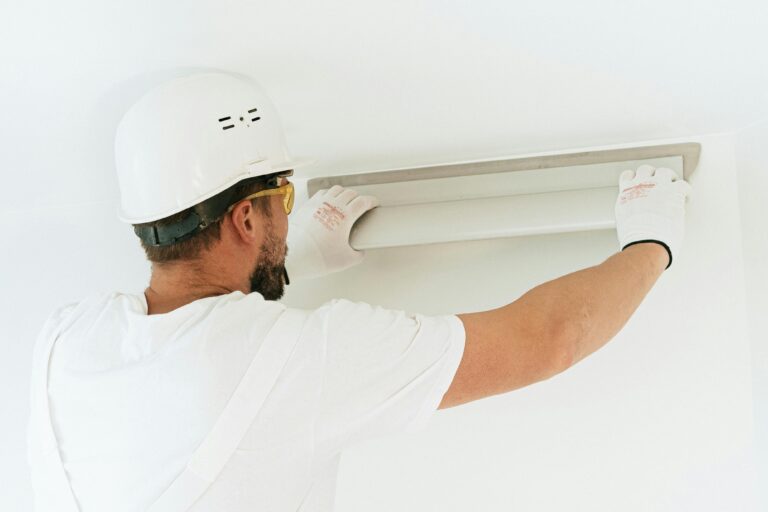 An electrician working on a lighting installation.