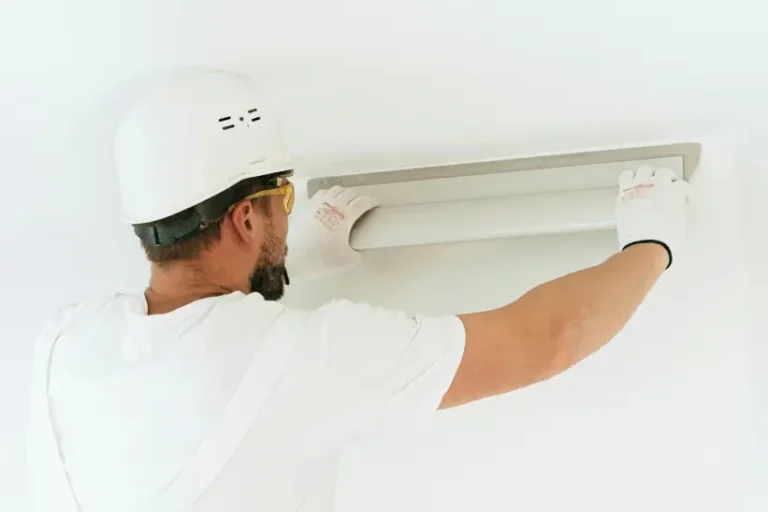 An electrician working on a lighting installation